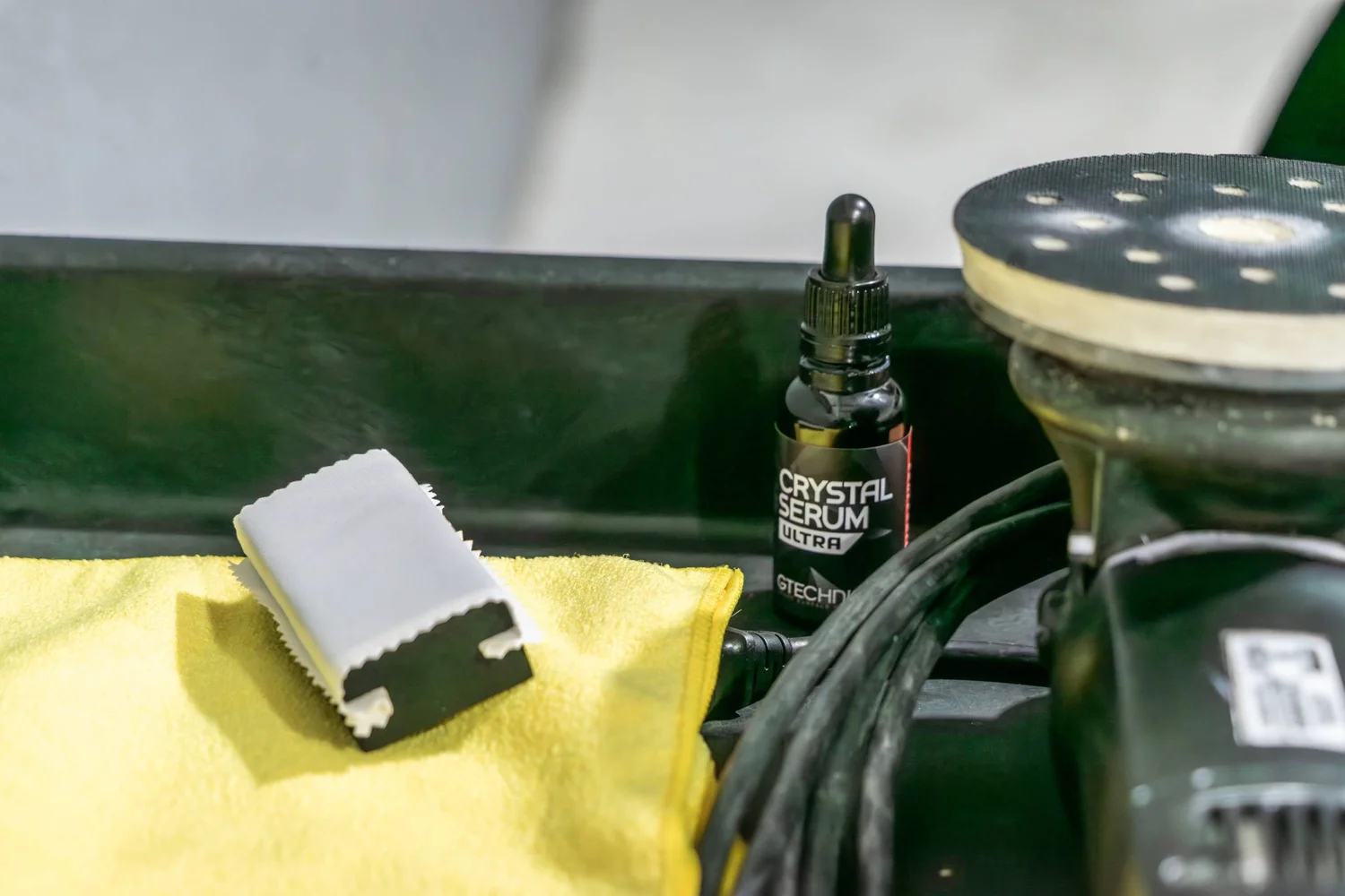 Coating products and polisher laid out on the workbench